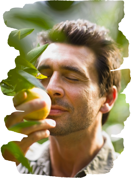 man smelling fruit