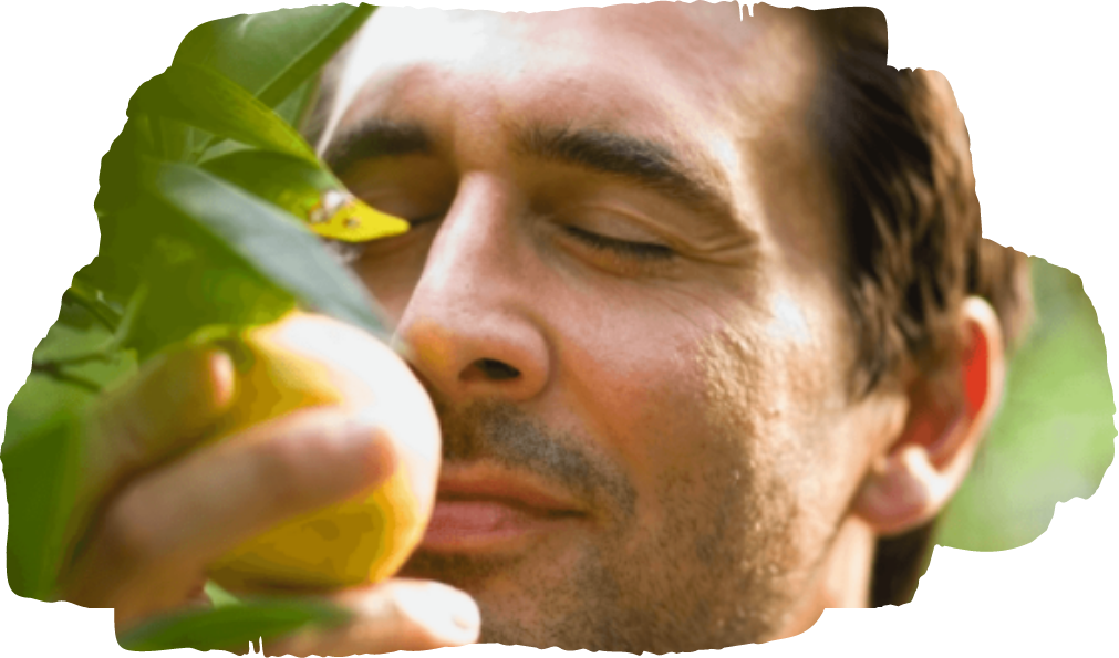 man smelling fruit