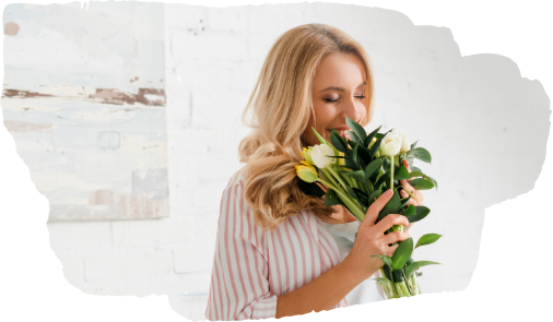woman smelling flowers indoor