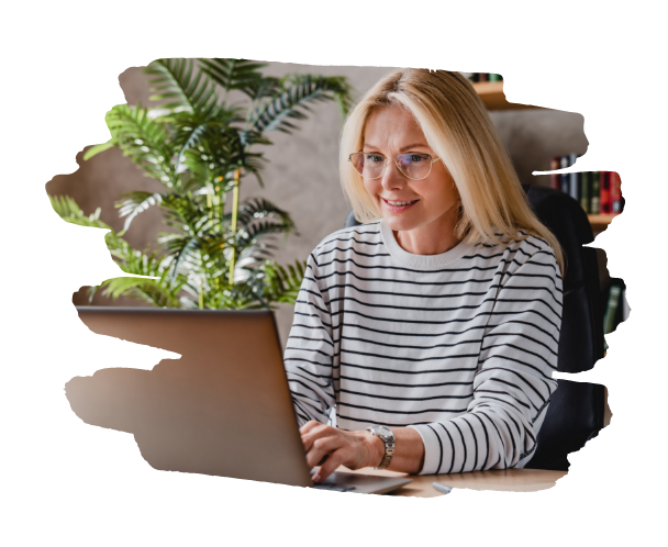 woman smiling typing on a laptop