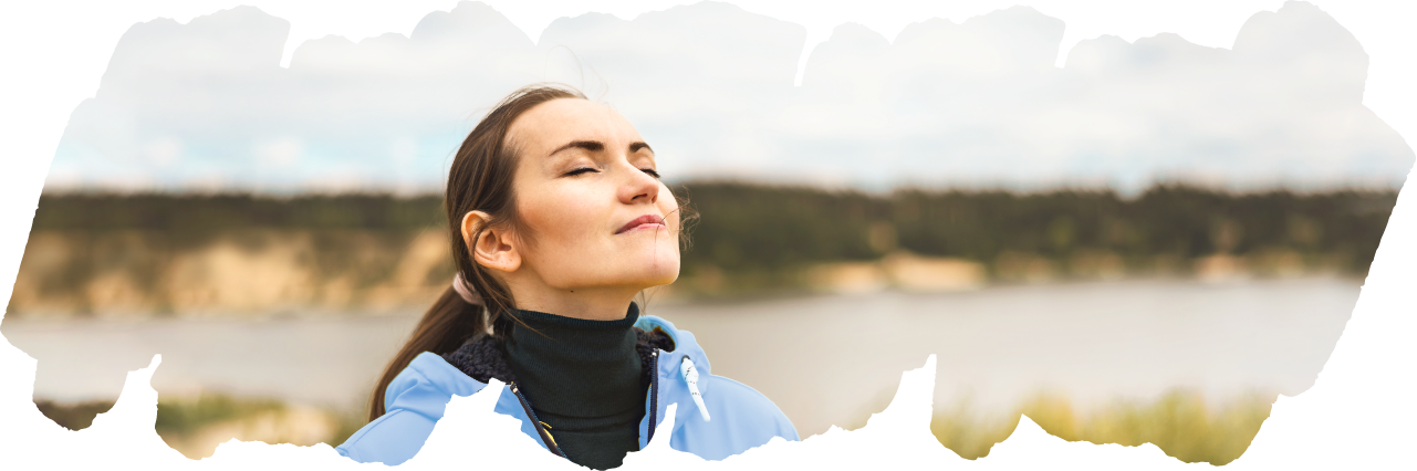 woman taking a deep breath outside