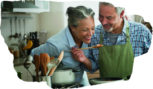 two people cooking and smelling food with joy